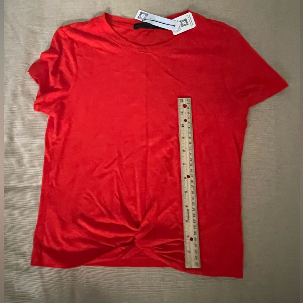 The brand is Sanctuary! This shirt is still intact with its tags!